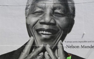 Un niño señala un poster de Mandela