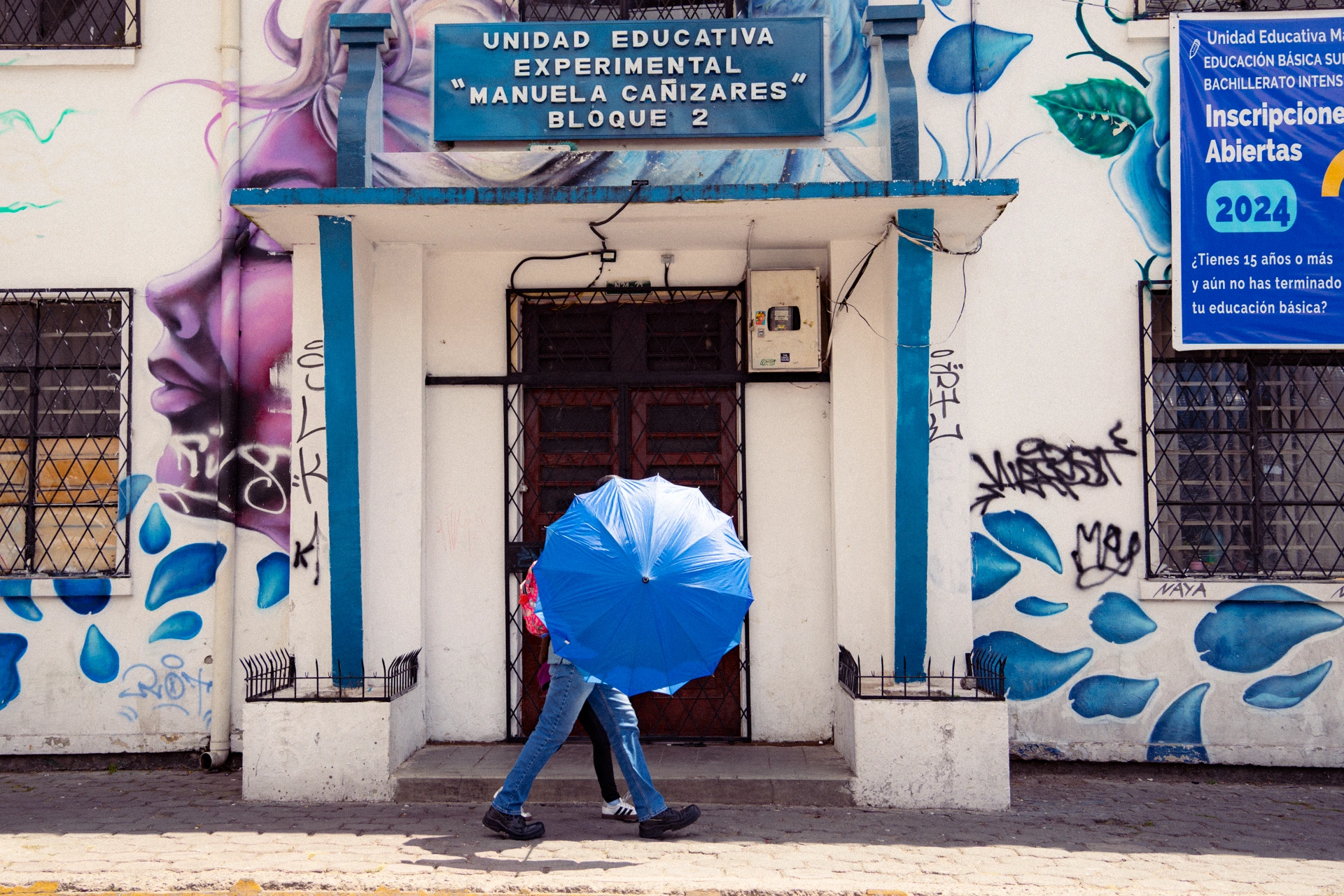 En una escuela fiscal, la entrada está flanqueada por estacas metálicas